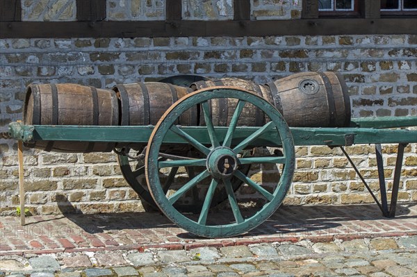 Antique handcart loaded with old wooden barrels