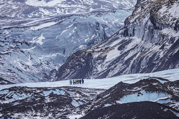 Tourists with guide visiting the glacier Falljökull