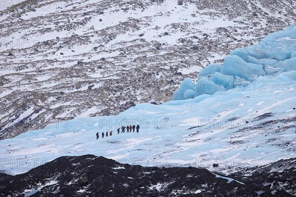 Tourists with guide visiting the glacier Falljökull