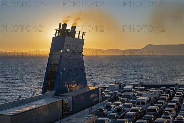 Car ferry from Grimaldi Lines sailing on the Adriatic Sea at sunset from Italy to Igoumenitsa in Greece