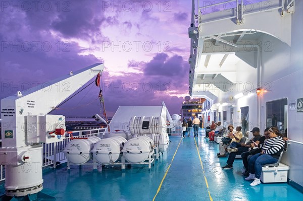 Passengers on board of ferry boat Kydon from San Juan in Puerto Rico to Santo Domingo in the Dominican Republic at sunset