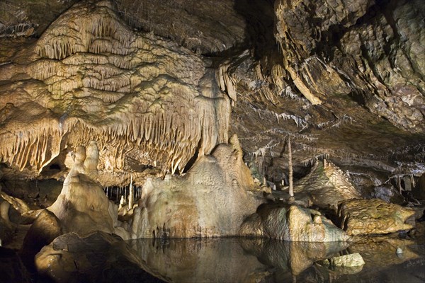 Stalactites and stalagmites and the river Lesse running through the Caves of Han-sur-Lesse