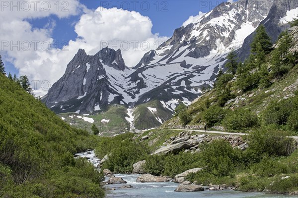 Hiker walking towards the Limestone Pyramids in Val Veny in the Italian Alps