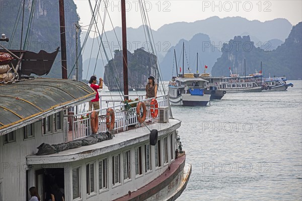 Tourist boats and limestone monolithic islands in Ha Long Bay