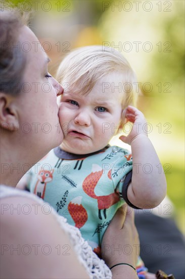 Mother comforting 11-month-old toddler