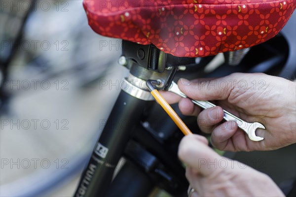 Height adjustment of a bicycle saddle