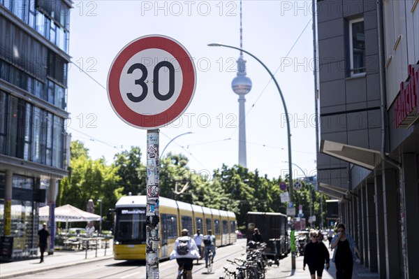 A speed 30 sign stands in the foreground of the TV Tower in Berlin