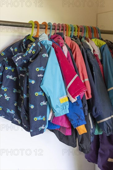 Children's jackets hanging on a coat rack in a kindergarten