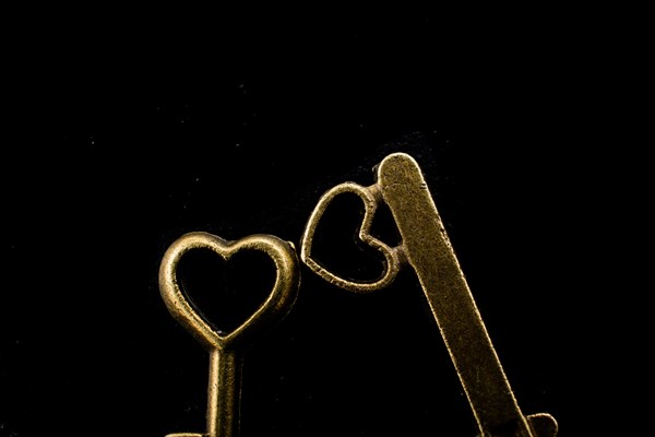 Heart shaped retro metal keys on dark background