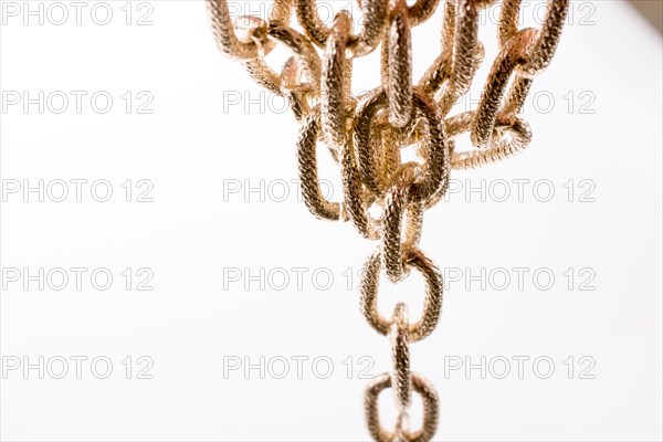 Gold color metal chain on white background