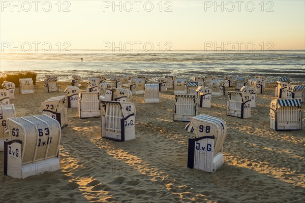 White beach chairs and mudflats