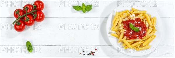 Penne Rigatoni Rigate Italian pasta in tomato sauce eat lunch dish on plate from above Panorama copy space Copyspace in Stuttgart