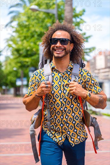 Smiling backpacker afro hair man on summer vacation