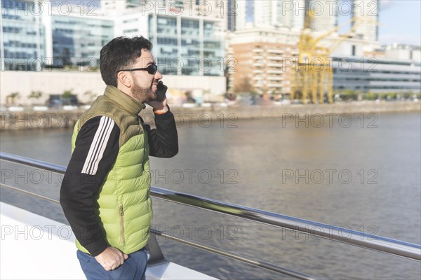 Latin man talking on the phone in Puerto Madero