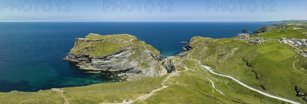 Aerial panorama of the rugged coastline on the Celtic Sea with the Tintagel Peninsula and the ruins of Tintagel Castle