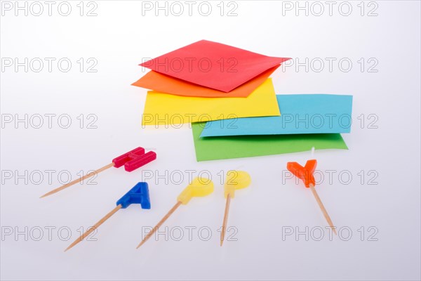 Colored envelopes and Color candles on sticks write happy