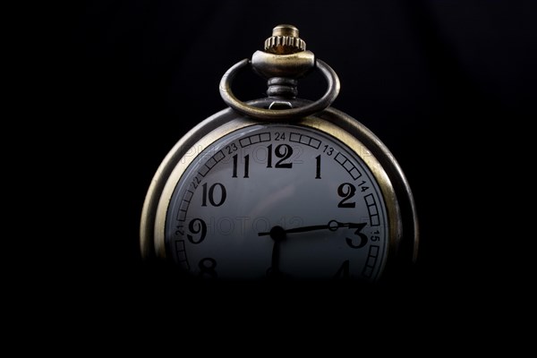 Retro style pocket watch on a dark background