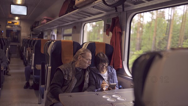 Elderly couple travel by train