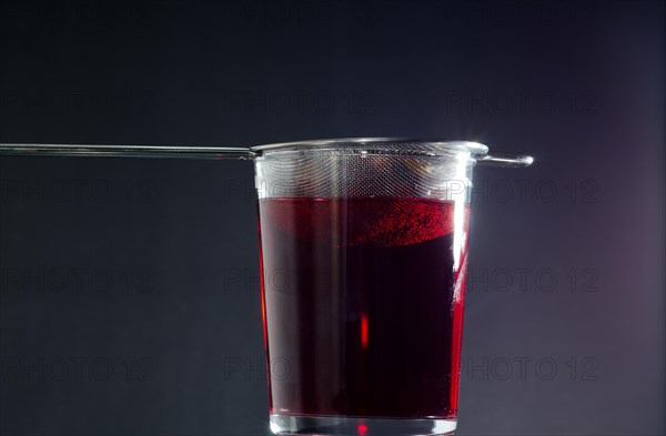 Drinking Glass with Strainer of Red Tea