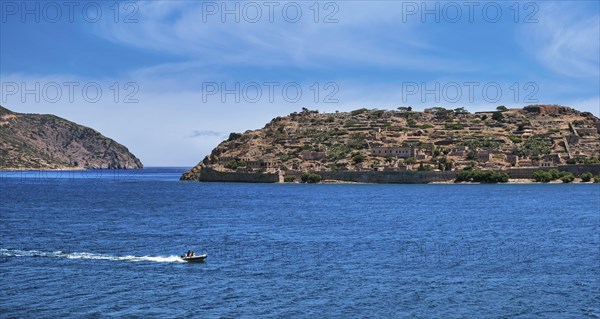 Beautiful view of west bank of Spinalonga island and Venetian fortress on clear sunny summer day on Crete