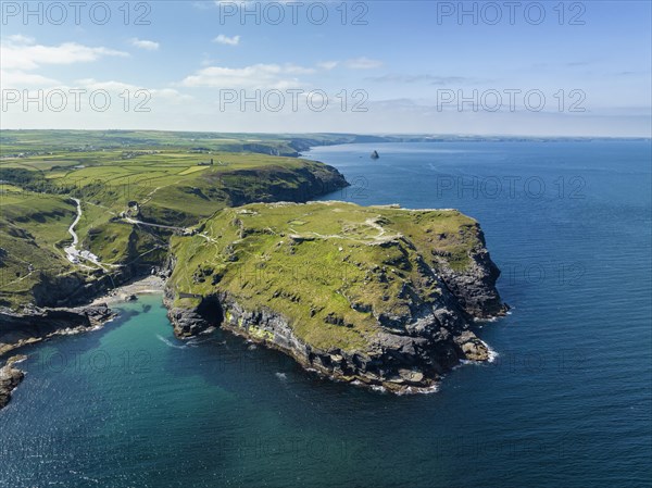 Aerial view of the rugged coastline on the Celtic Sea with the Tintagel Peninsula and the ruins of Tintagel Castle