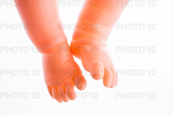 Baby doll's legs on a white background