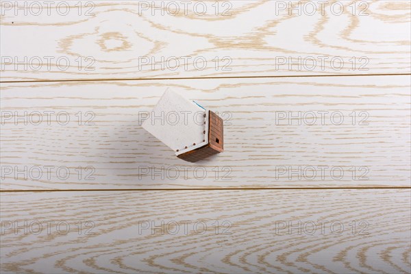 Little model house and on a parquet background