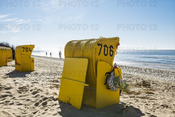 Yellow beach chairs and mudflats