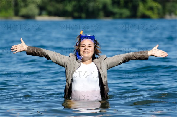 Business Woman with Suit and Diving Mask in the Water with Arms Outstretched