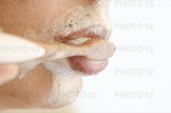 Woman Brushing the Teeth with a Toothbrush