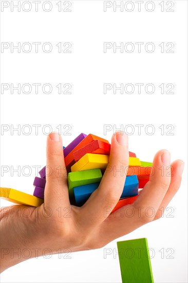 Falling colorful domino onto a hand