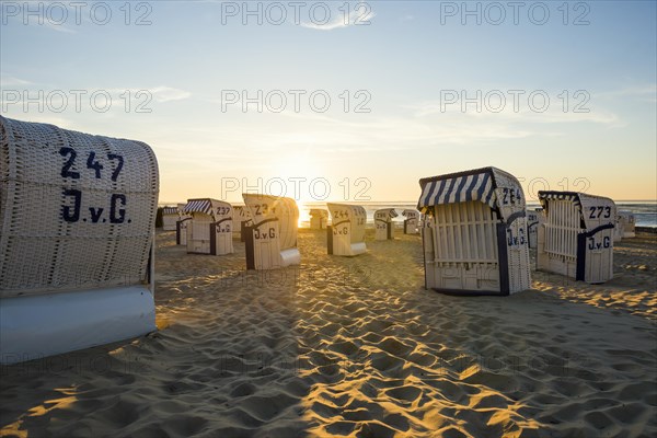 White beach chairs and mudflats