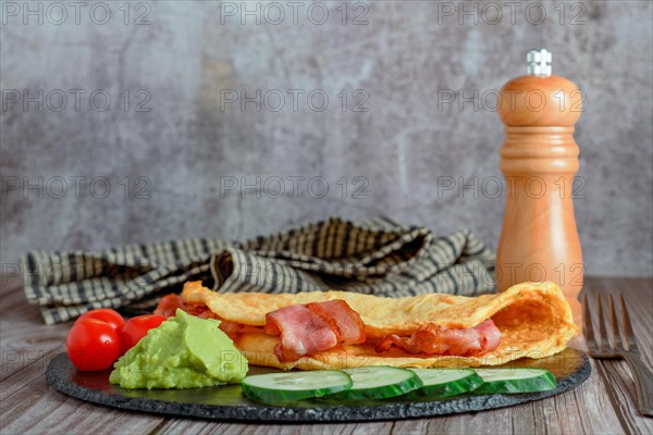 Bacon stuffed omelette with cucumber