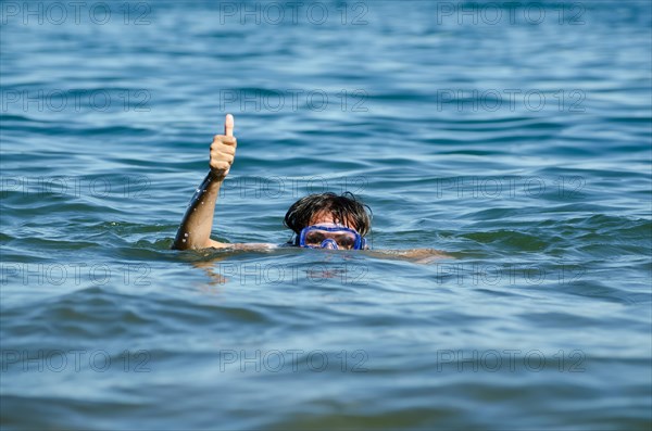 Woman with Diving Mask in the Water and Showing the Thumb Up