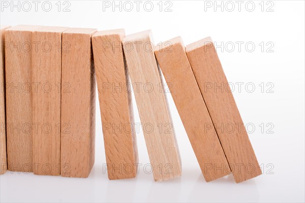 Wooden Domino Blocks in a line on a white background