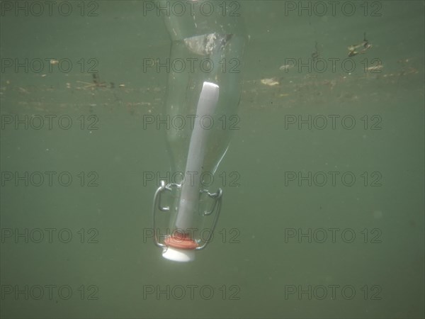 Message in a bottle and floating underwater