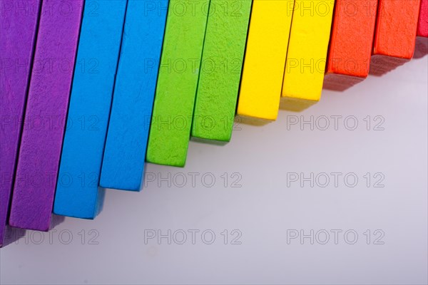 Colorful Domino Blocks in a line on a white background