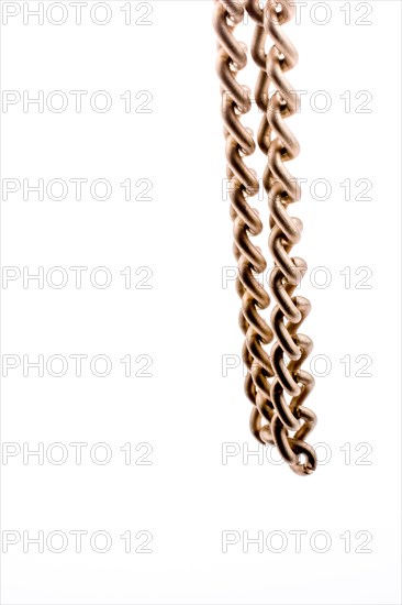 Gold color metal chain on white background