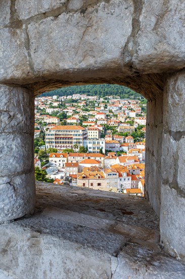 View of the old town through an opening in the wall of the fortress in Dubrovnik