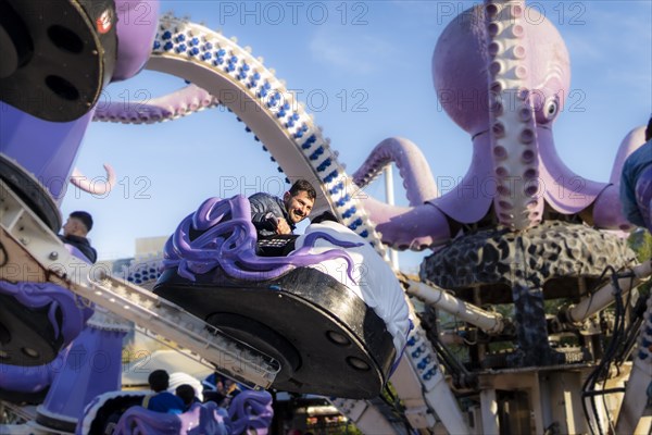 Latin man having fun at an amusement park