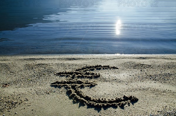 Euro Symbol on the Sand Beach with Sunlight