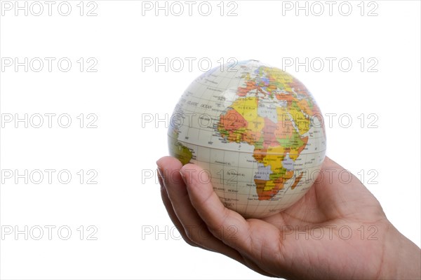 Child holding a small model globe in hand on white background