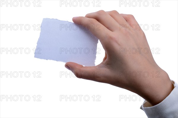 Hand holding a piece of blank torn notepaper