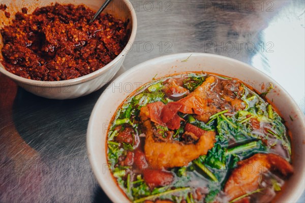 Close up of a bowl of Vietnamese Fried Fish Vermicelli Noodle Soup called Bun Ca