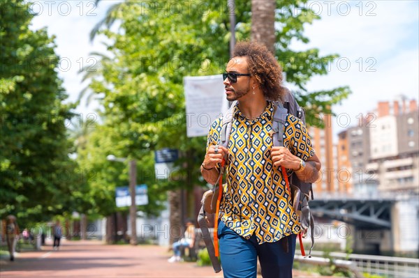 Afro hair man backpacking on summer vacation