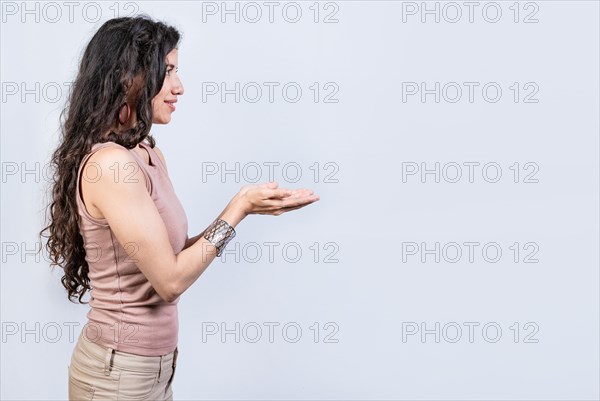 Smiling girl recommending a product with her hands