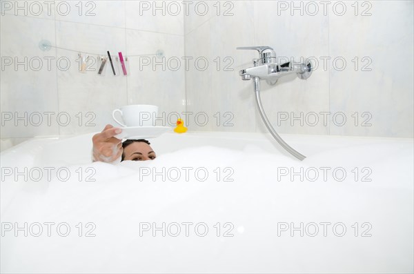 Woman Drinking a Coffee in the Bathtub with Foam