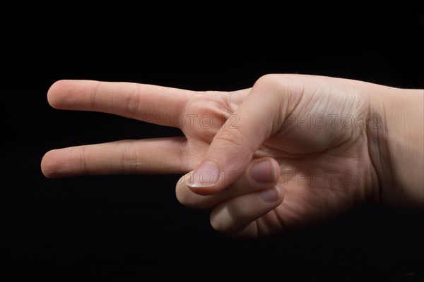 The sign of victory and peace in black background