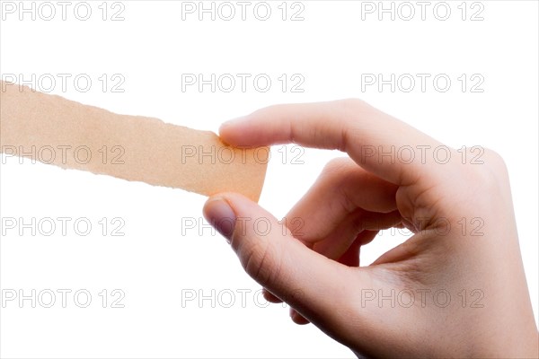 Hand holding a piece of blank torn notepaper