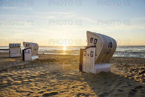 White beach chairs and mudflats